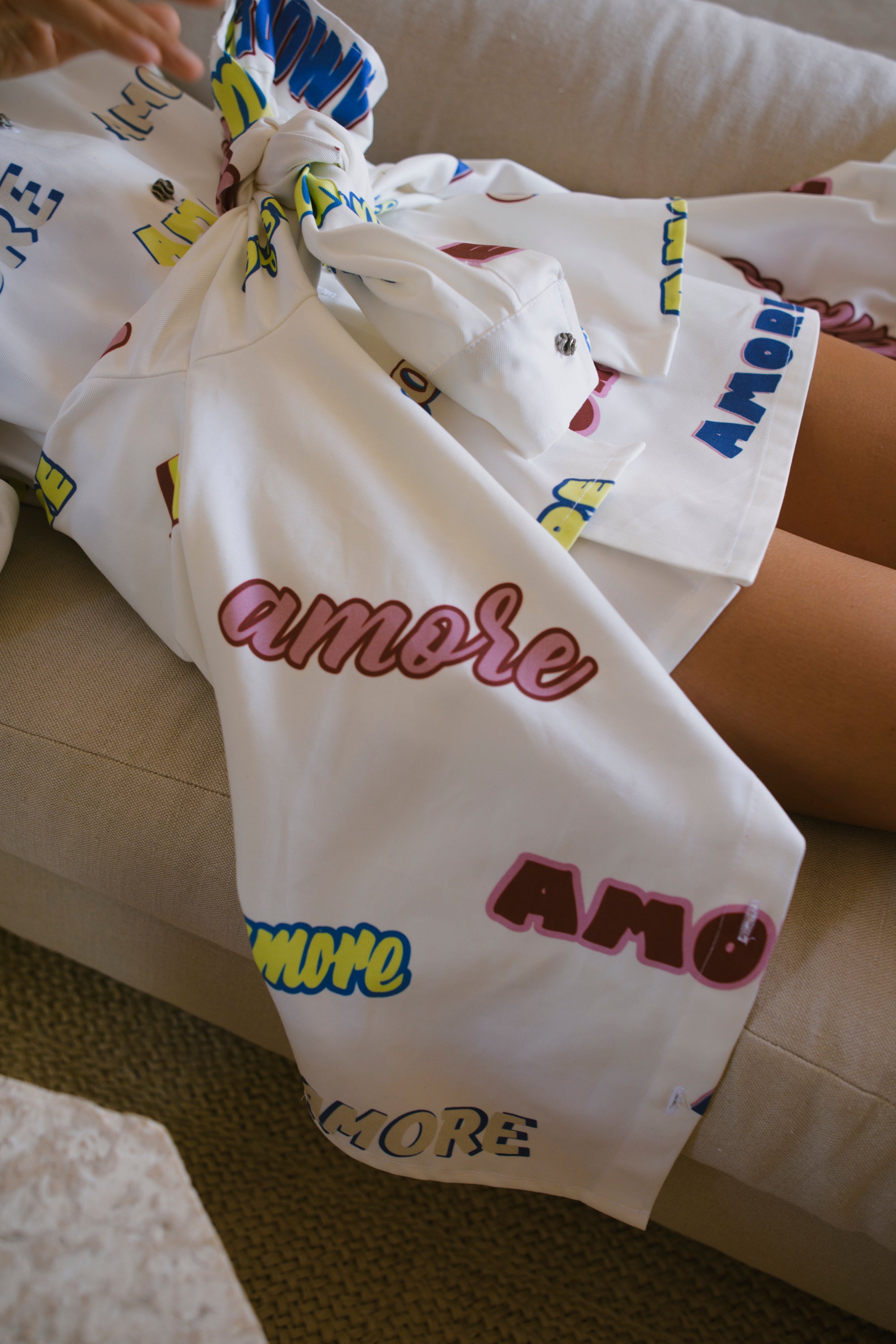 White skirt with colorful text and patterns on a couch